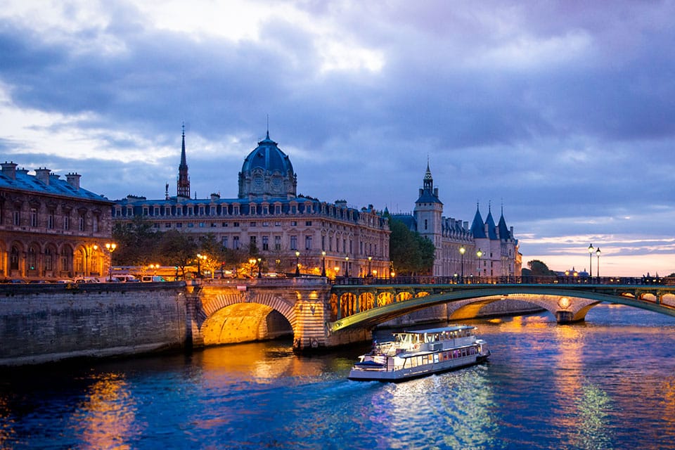 Scenic cruise boat at night on the river Seine in Paris, book your tickets at GetYourTicket - Paris Whatsup
